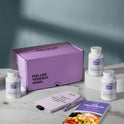A product bundle display for GleeFull Supplements on a marble surface against a blue  background. The layout includes a large purple shipping box featuring the slogan 'FEEL LIKE YOURSELF AGAIN.', three white bottles of Meno Gut Advanced, a purple branded pen, a matching notepad that reads 'REMINDERS WHEN I'M HAVING A MENOPAUSE MOMENT', and a recipe booklet titled 'THE MENOPAUSE Recipes'