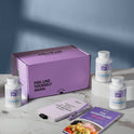 A product bundle display for GleeFull Supplements on a marble surface against a blue background. The layout includes a large purple shipping box featuring the slogan 'FEEL LIKE YOURSELF AGAIN.', three white bottles of Meno Belly Flusher, a purple branded pen, a matching notepad that reads 'REMINDERS WHEN I'M HAVING A MENOPAUSE MOMENT', and a recipe booklet titled 'THE MENOPAUSE Recipes'