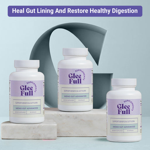 Three white GleeFull Meno Gut Advanced bottles on marble blocks against a light blue-grey background. Purple banner reads: 'Heal Gut Lining And Restore Healthy Digestion'. Labels read 'Supports Beneficial Gut Flora, Meno Gut Advanced, 30 Capsules'.